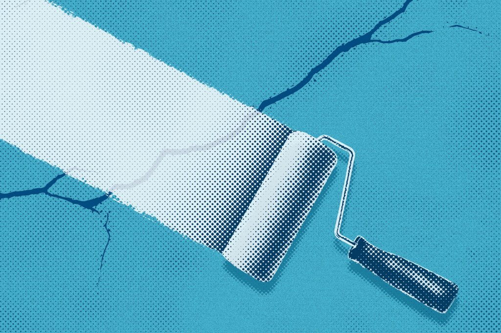 Paint roller covering cracks representing designing on broken systems and weak brand strategy